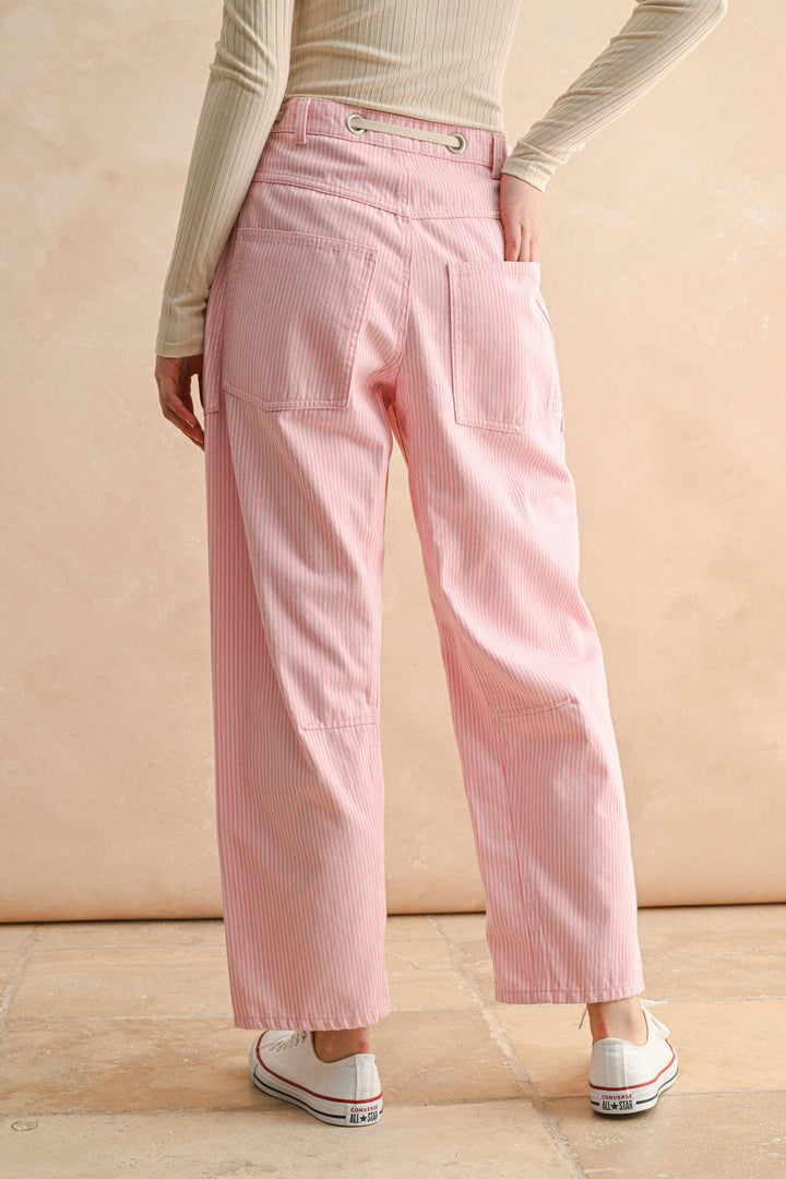 Woman wearing pink striped pants spring or summer light barrel leg pants 