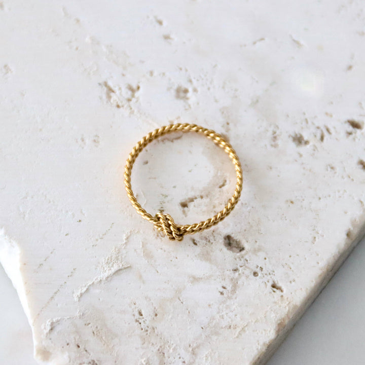 Small gold stacking ring with rope and knot design