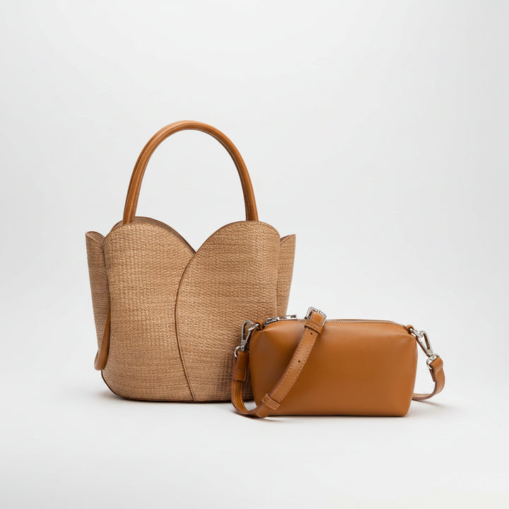 Two brown handbags, one woven raffia and one leather, on a white background