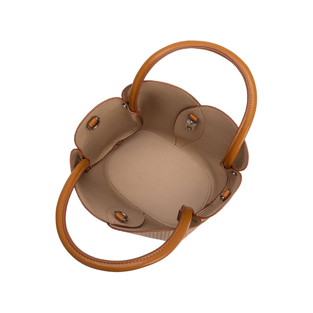Brown woven raffia handbag with brown handles on a white background