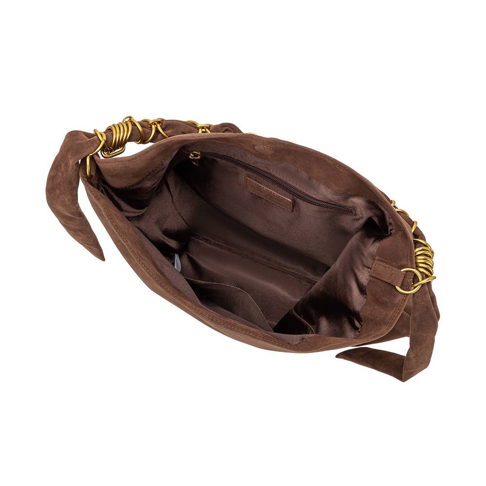 A dark brown suede shoulder bag with a gold chain strap, shown from an overhead angle to display its interior compartments and lining against a white background.