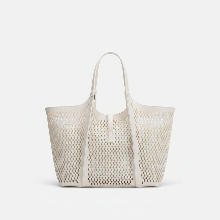 White perforated vegan leather tote bag with optional shoulder strap.