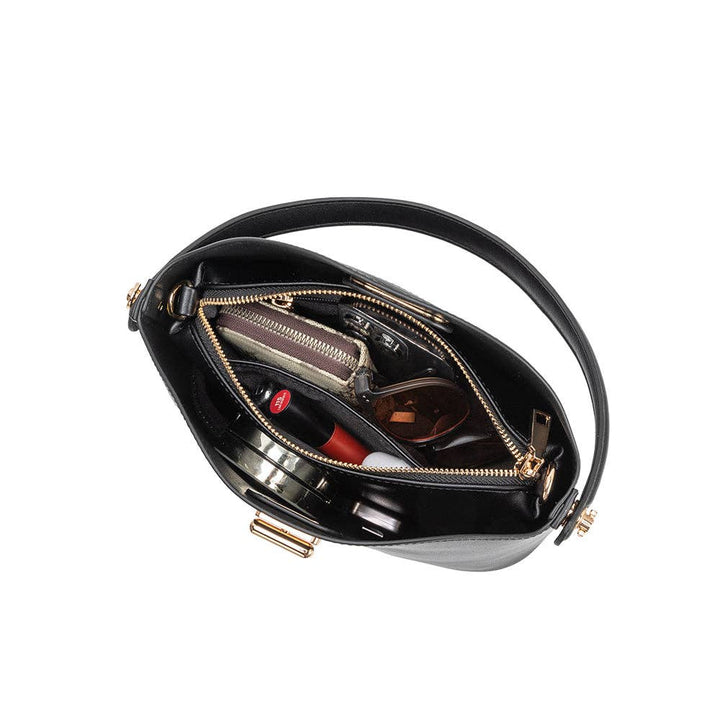 Black vegan leather handbag with gold accents open on a white background