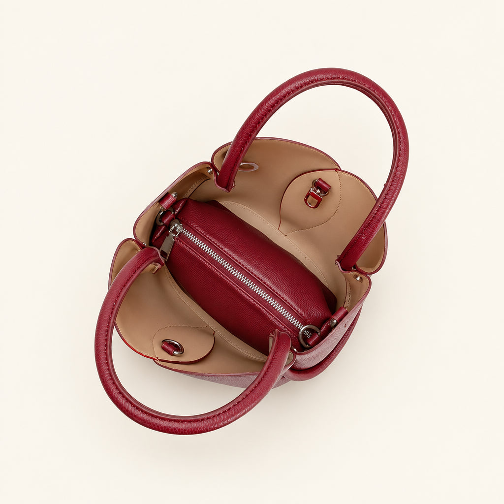 Interior of a top handle bag with burgundy and beige colors on a white background
