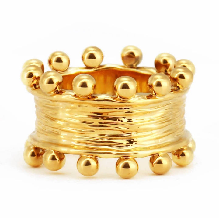 Gold ring with bead-like embellishments on a white background