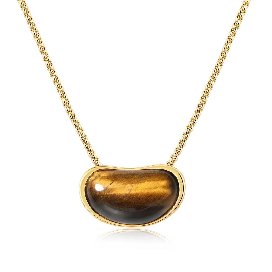 Necklace with a tiger's eye stone pendant on a gold chain against a white background