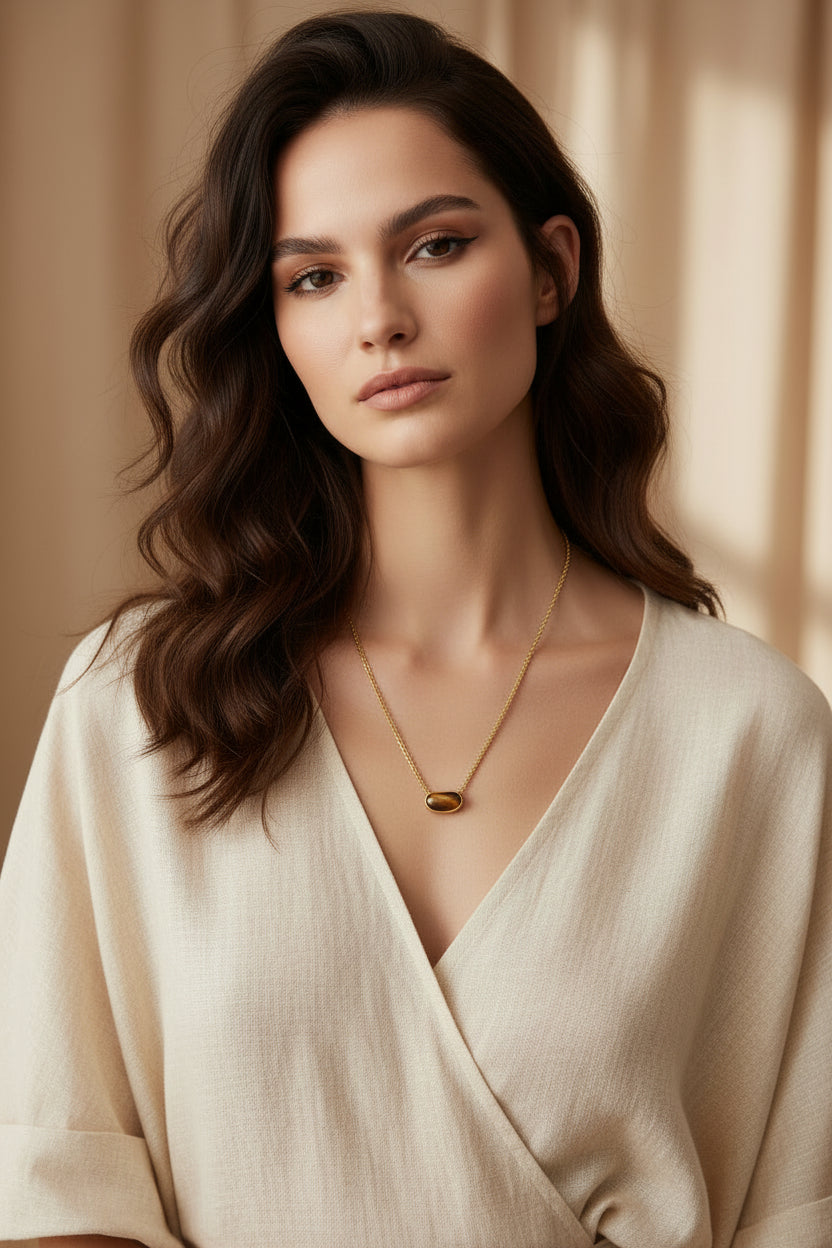 Model wearing gold plated water proof and tarnish resistant, hypoallergenic tiger's eye pendant adjustable slide necklace.