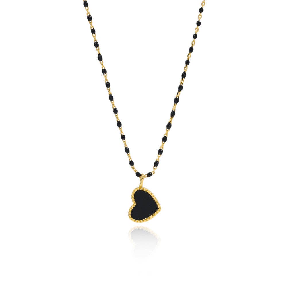 Necklace with black heart pendant and gold chain on a white background