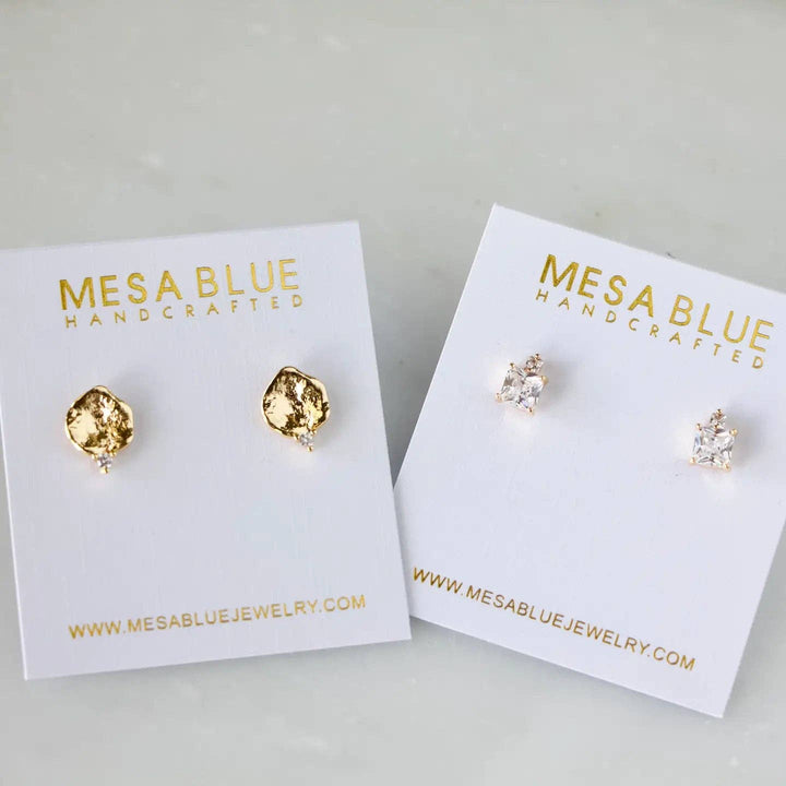 Two pairs of stud earrings on Mesa Blue branded card holders.