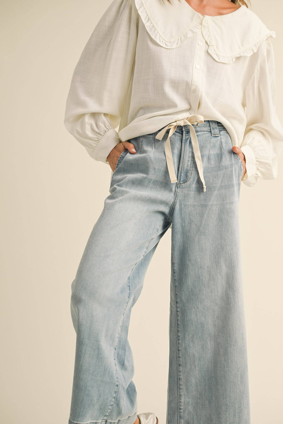 Woman wearing light blue denim wide leg jeans on 