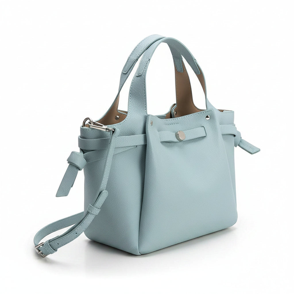 Light blue shoulder handbag with optional strap on a white background