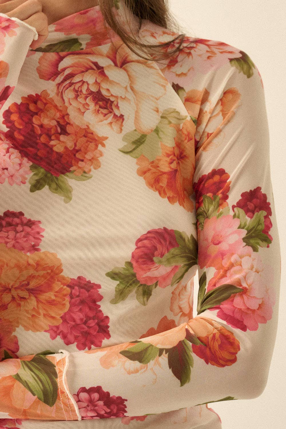 Floral patterned mesh fabric with large flowers on a beige background