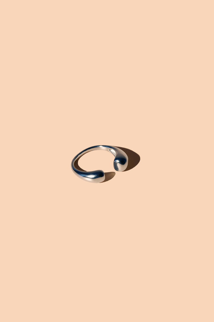 Silver ring on a beige background