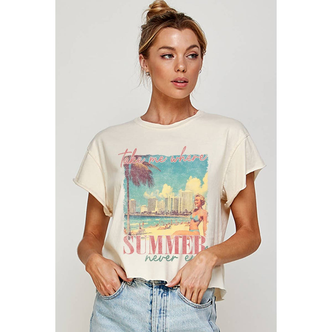 Woman wearing a cream t-shirt with a graphic design and text, standing against a plain background.