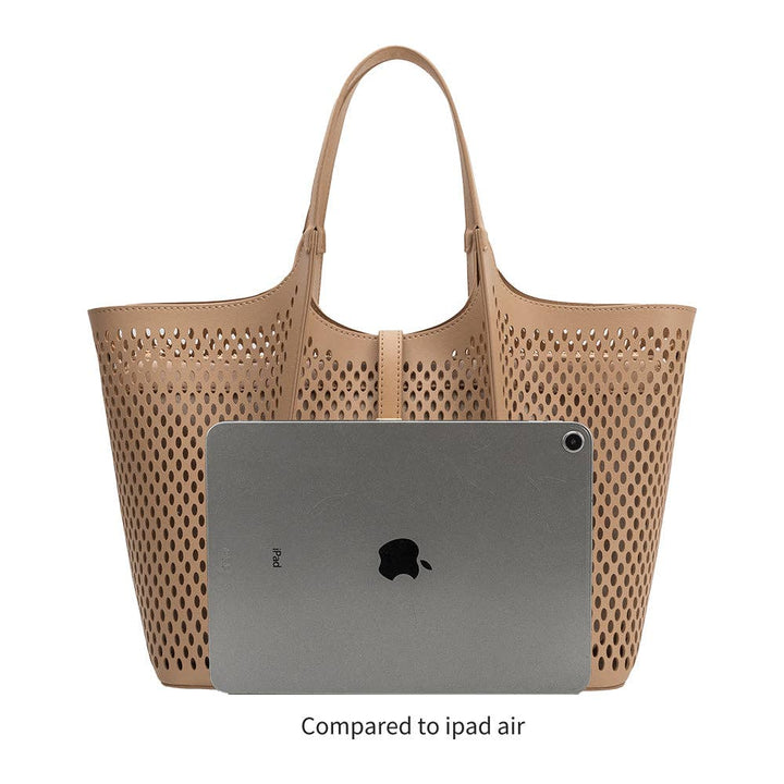 Beige vegan leather perforated tote handbag with an iPad Air inside to show bag can fit ipad