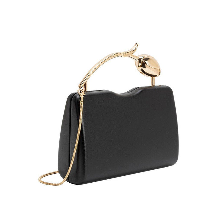A black faux-leather clutch handbag with a curved top handle and a gold-tone chain strap, photographed on a solid white background.