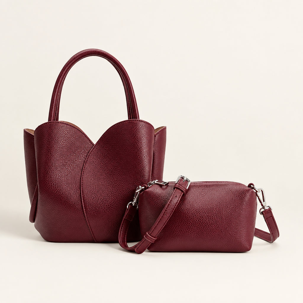 Two maroon handbags, one with a shoulder strap and the other with handles, on a white background.