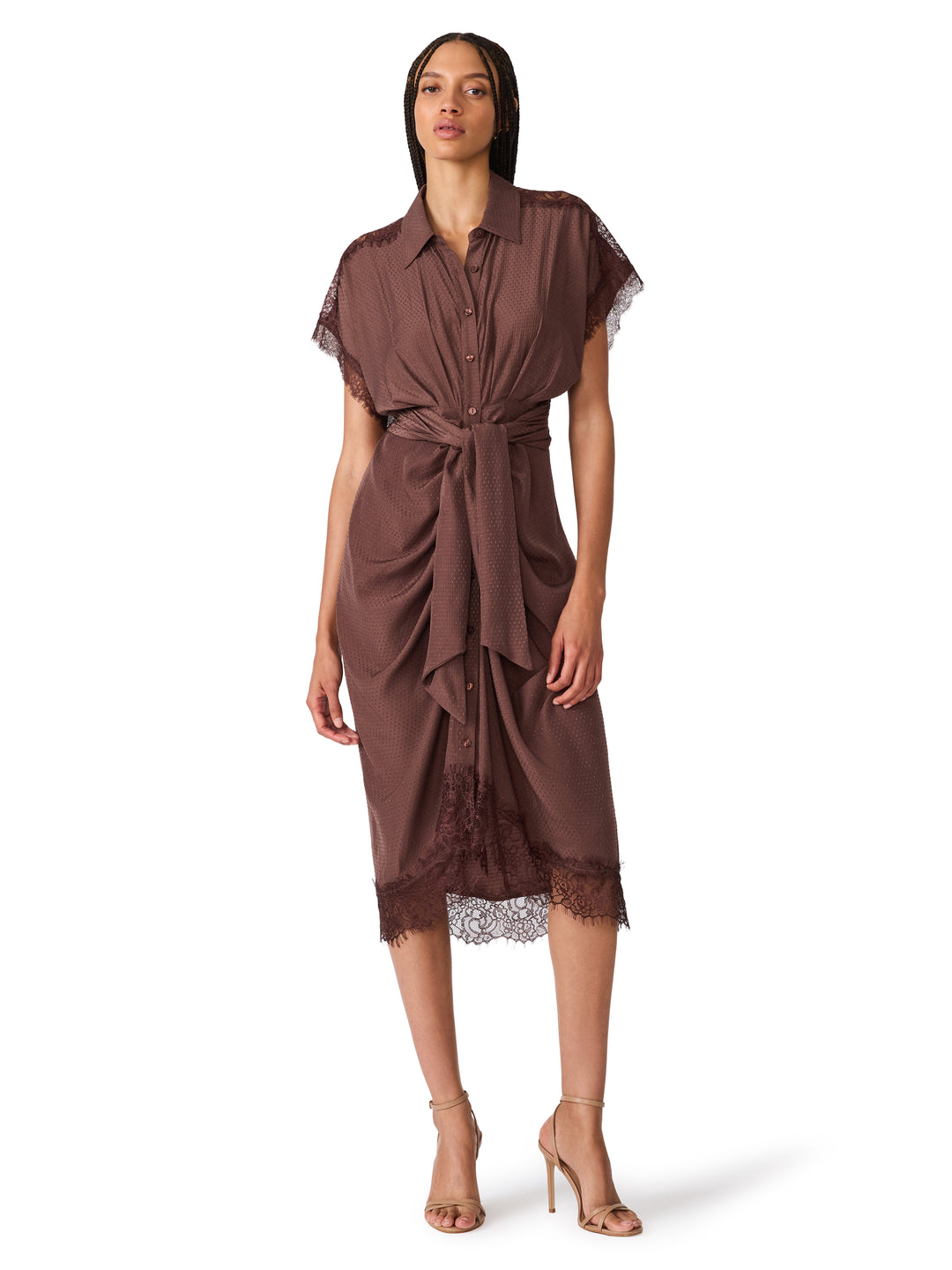 A woman modeling a brown short-sleeve midi shirt dress with lace trim and a tie waist, photographed against a plain white studio background.