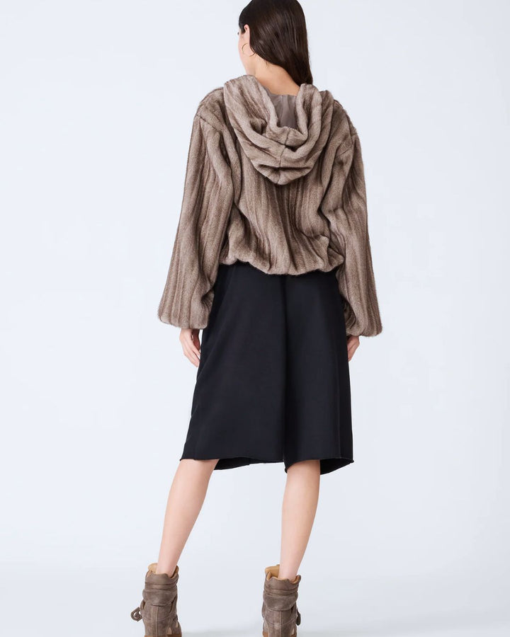 woman wearing gray faux fur cropped jacket with hood