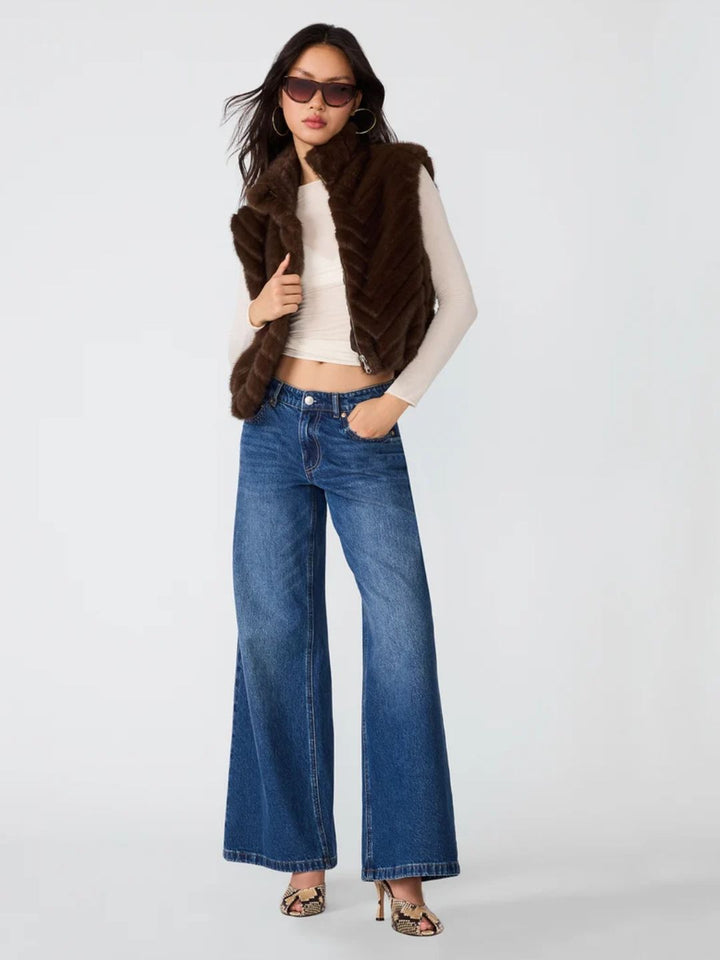 Woman wearing faux fur vest in dark brown