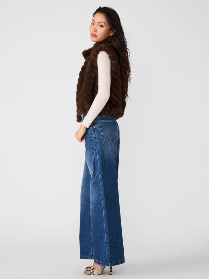 Woman wearing a plush chevron faux fur vest in dark brown