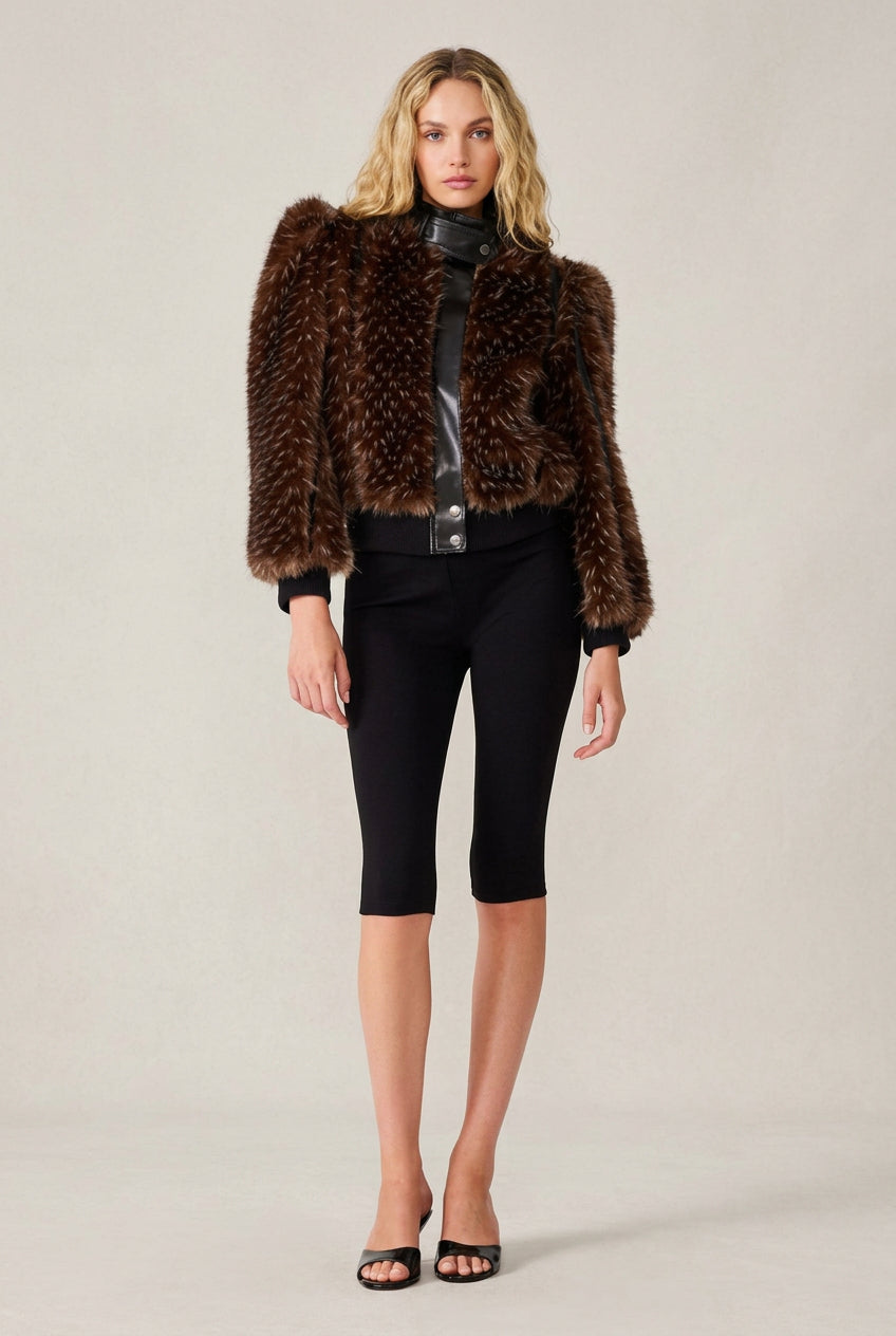 Wman wearing faux fur cropped jacket with vegan leather trim