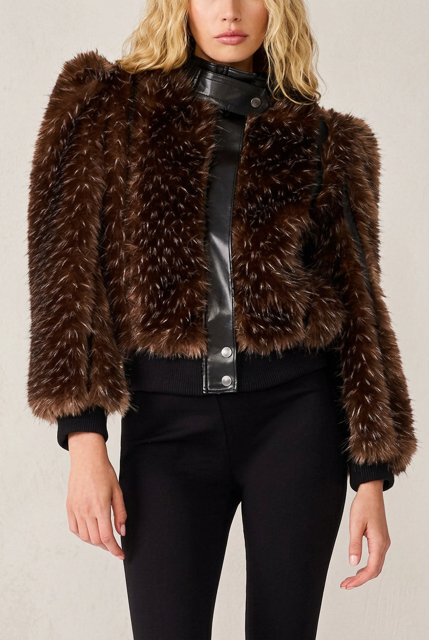 Woman wearing brown faux fur and faux leather trim jacket