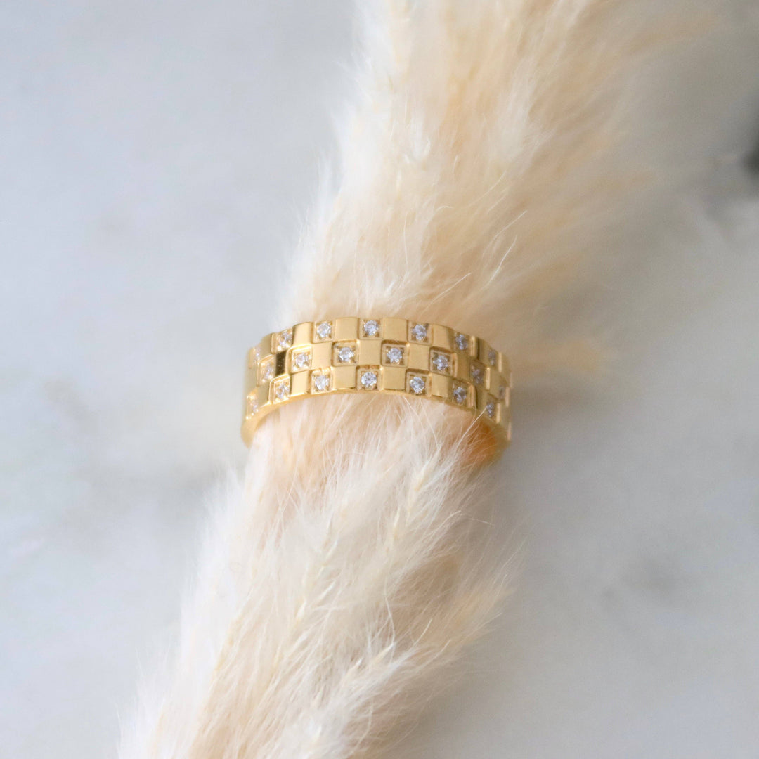 Gold ring with small diamond - like CZ stones.