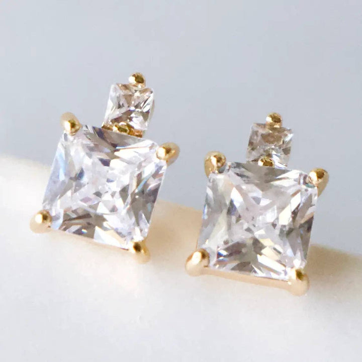 Pair of gold and CZ stud earrings.