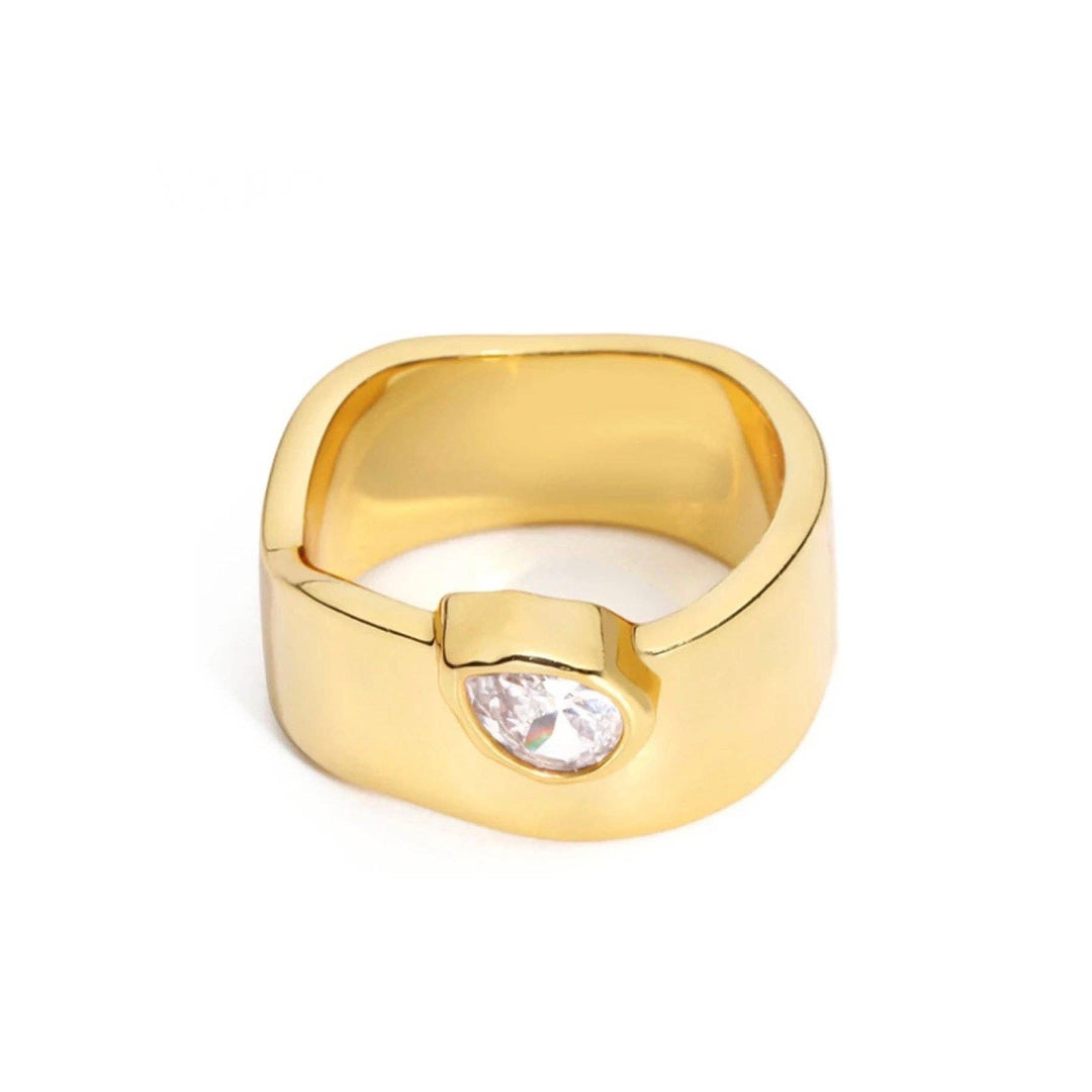 Gold ring with a cubic zirconia gemstone on a white background