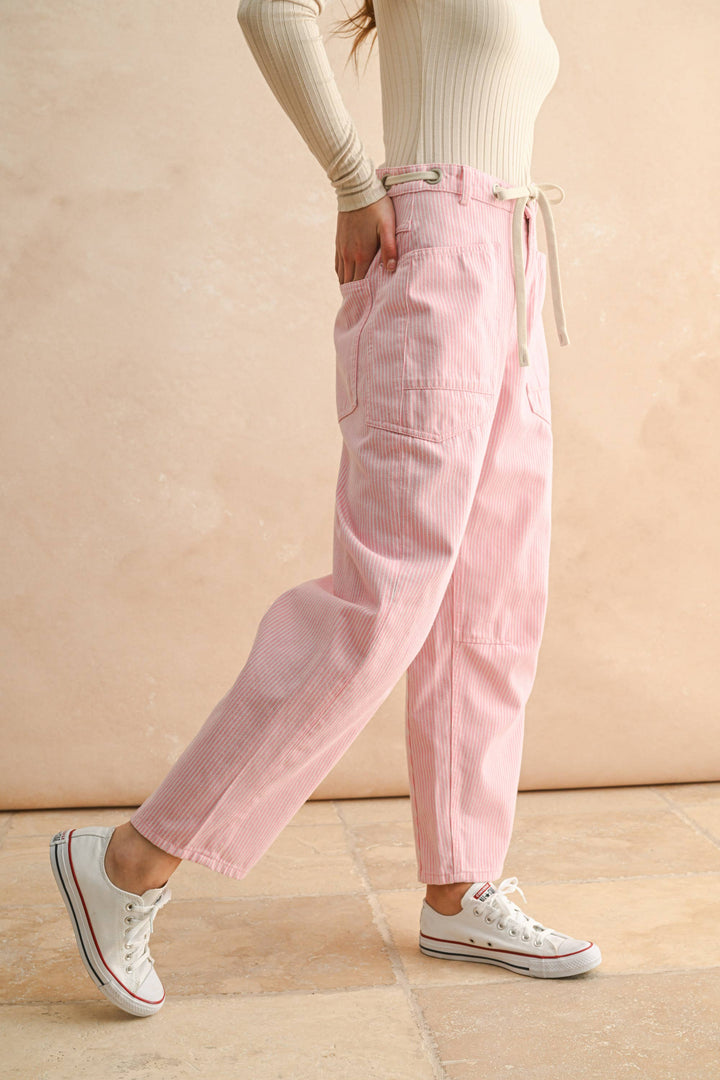 Person wearing pink pants with drawstring and cropped barrel leg