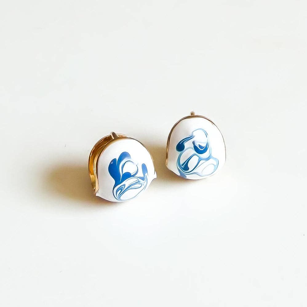 Pair of earrings with blue floral design on a white background