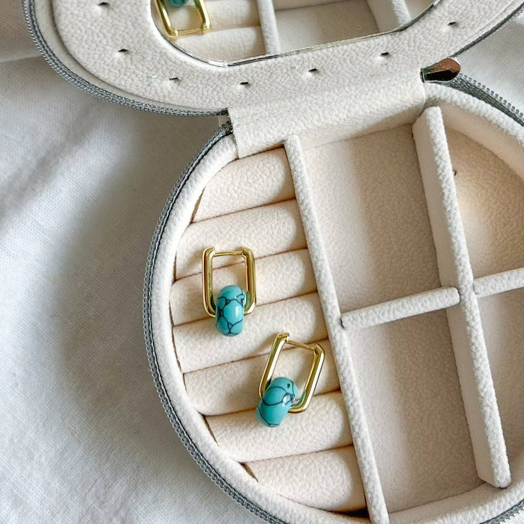 Turquoise hoop earrings in a jewelry box