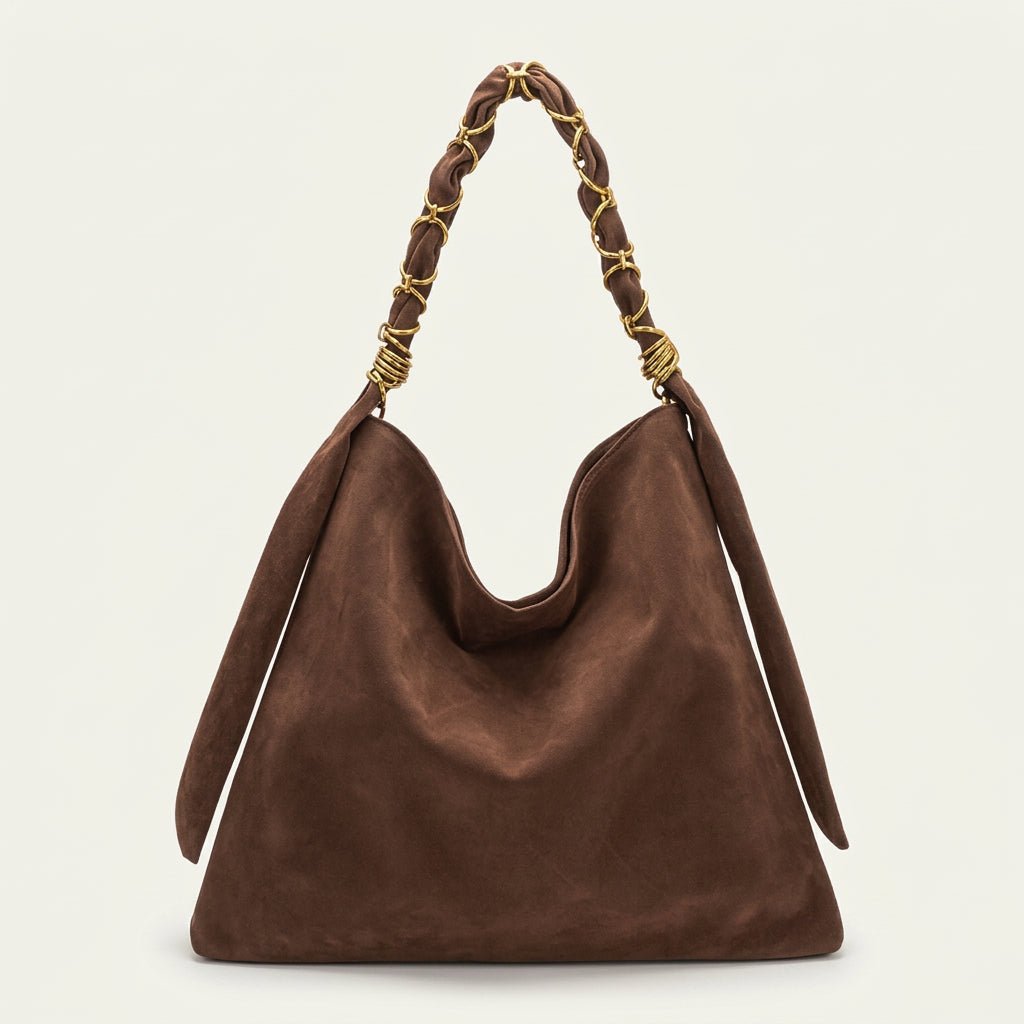 A dark brown suede slouchy shoulder bag with a braided top handle featuring gold-tone metal accents.