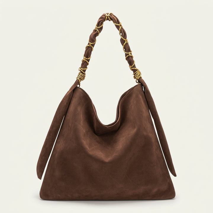 A dark brown suede slouchy shoulder bag with a braided top handle featuring gold-tone metal accents.