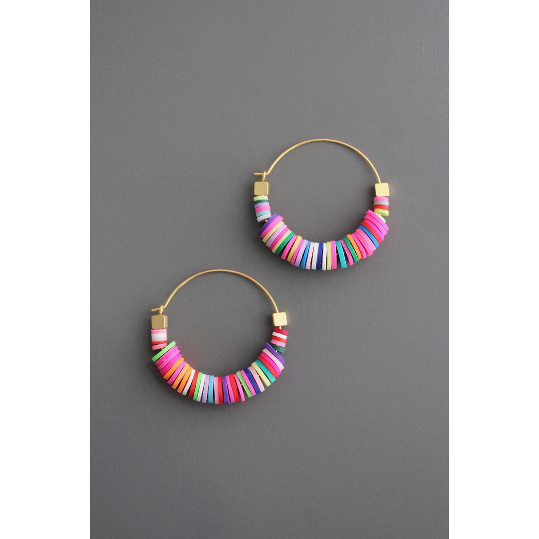 Colorful beaded hoop earrings on a gray background