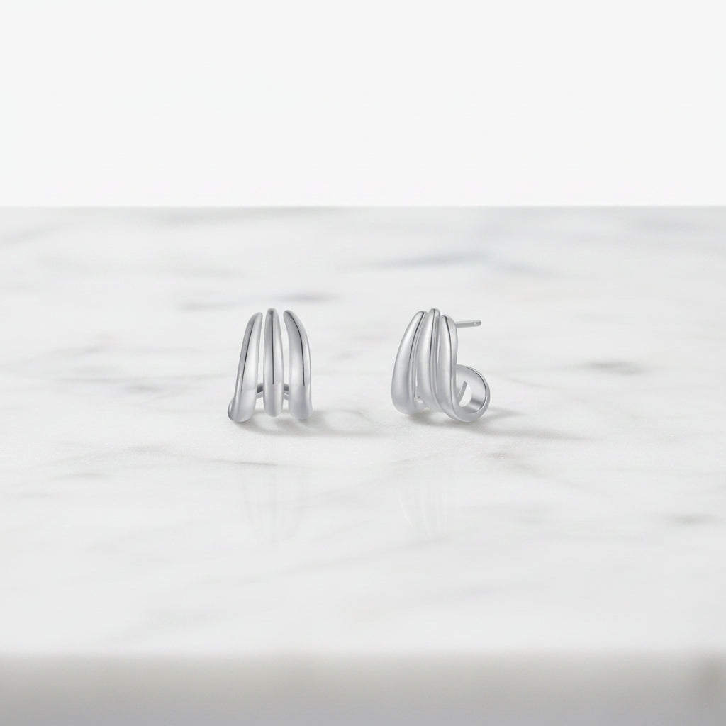 Pair of silver hoop earrings on a white background