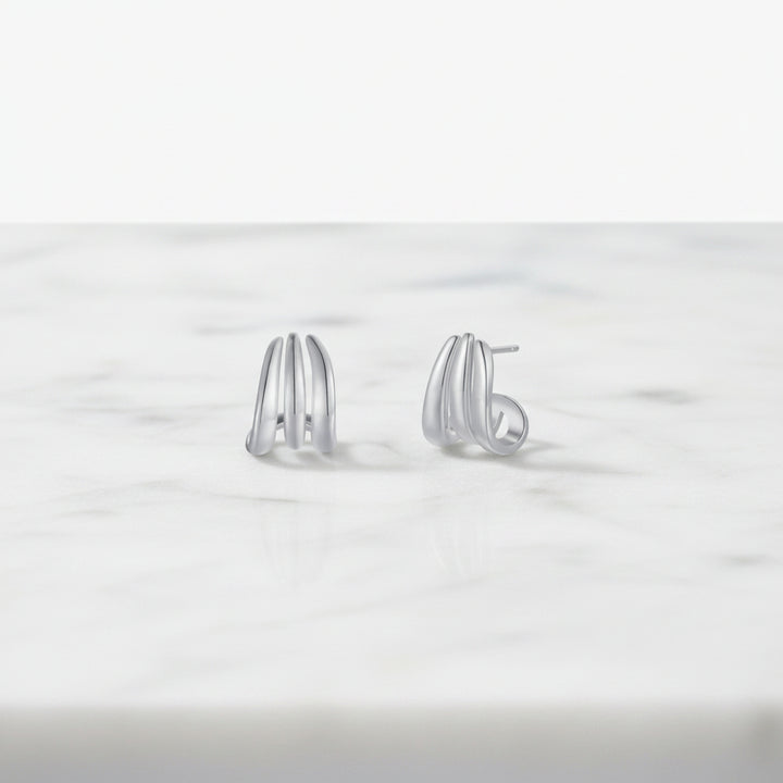 Pair of silver hoop earrings on a white background