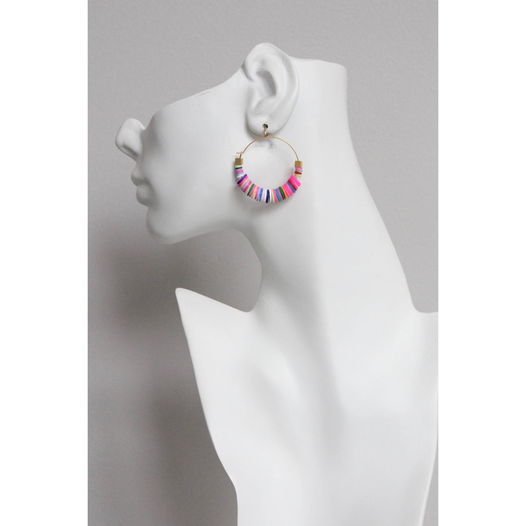 Colorful beaded hoop earring on a mannequin ear against a gray background