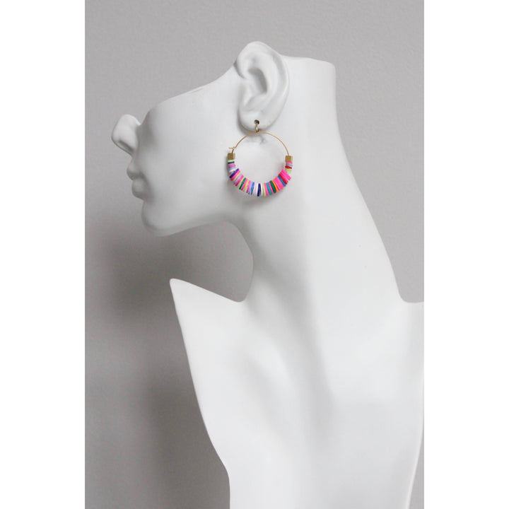 Colorful beaded hoop earring on a mannequin ear against a gray background
