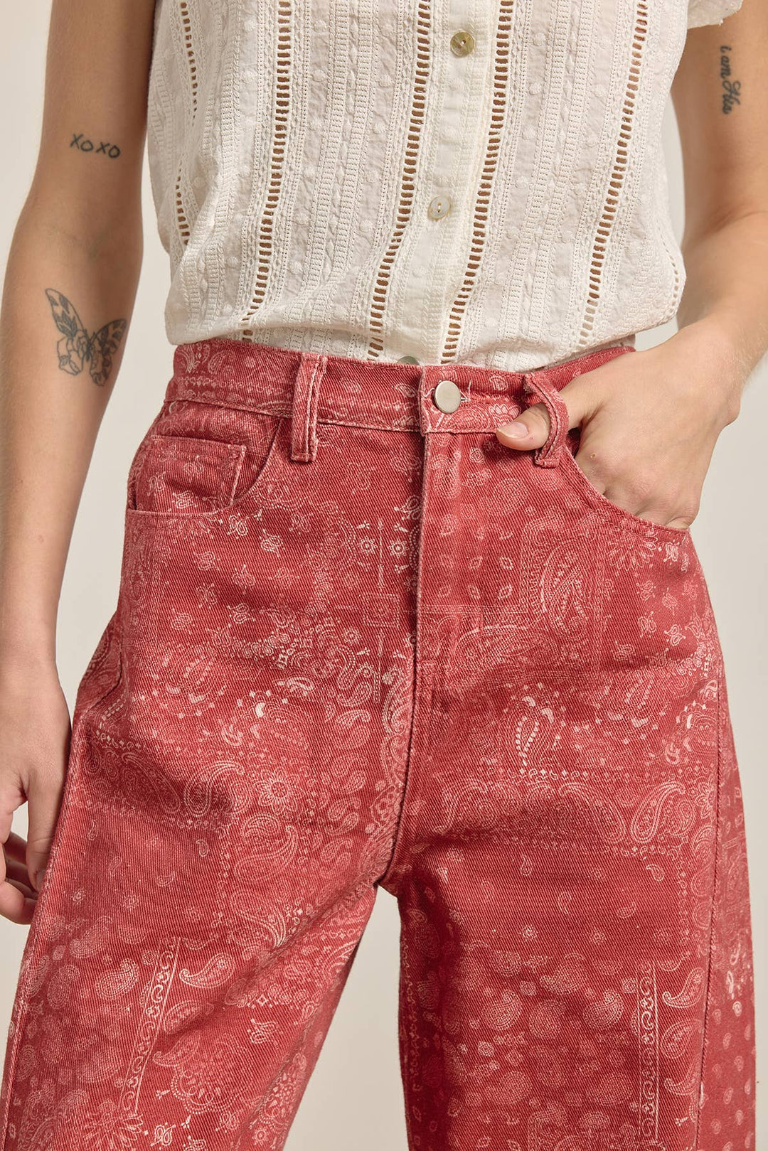 Woman wearing red paisley print wide leg denim pants