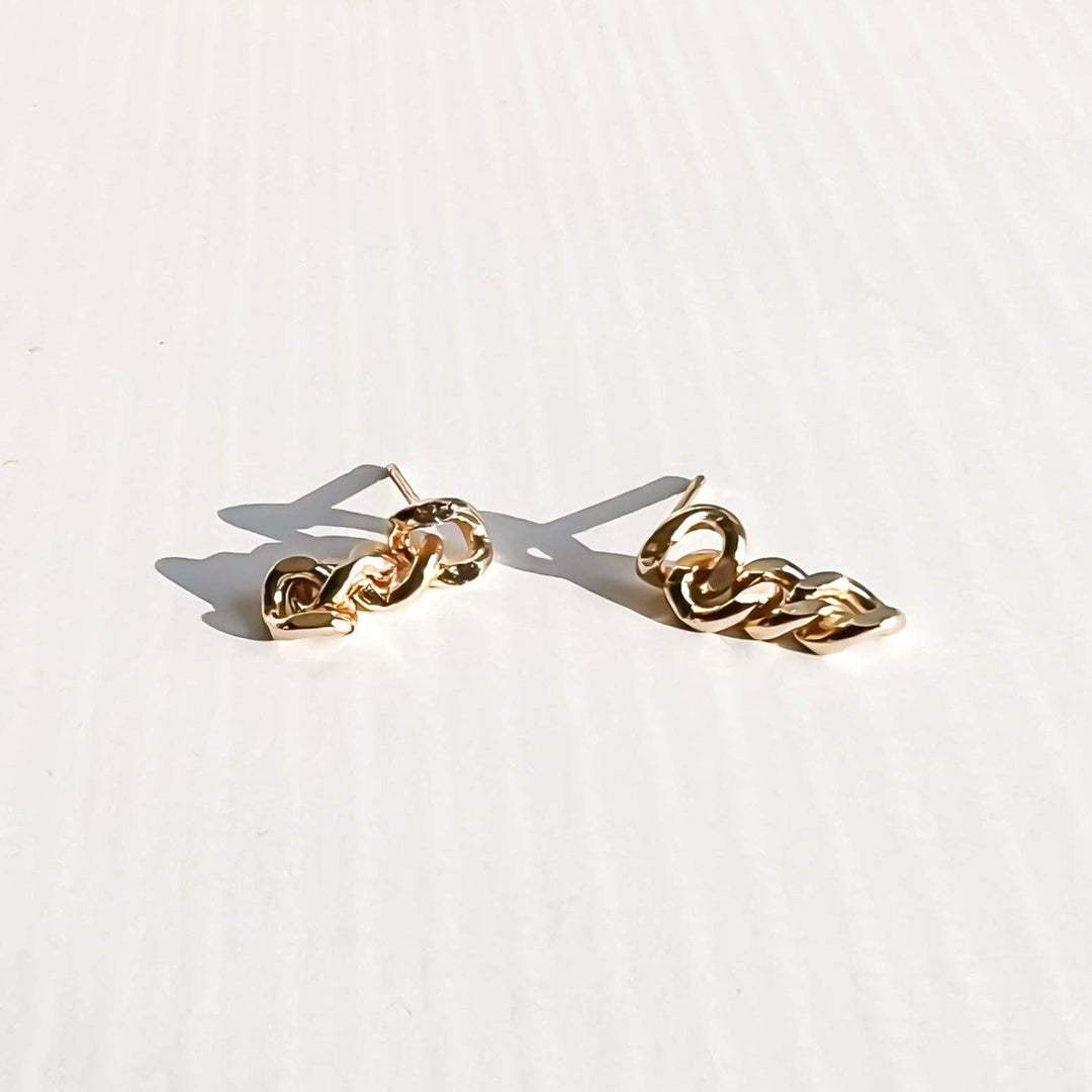 Gold chain earrings on a white background