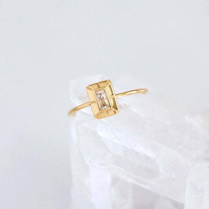 Art Deco Gold ring with a rectangular stone on a light gray background