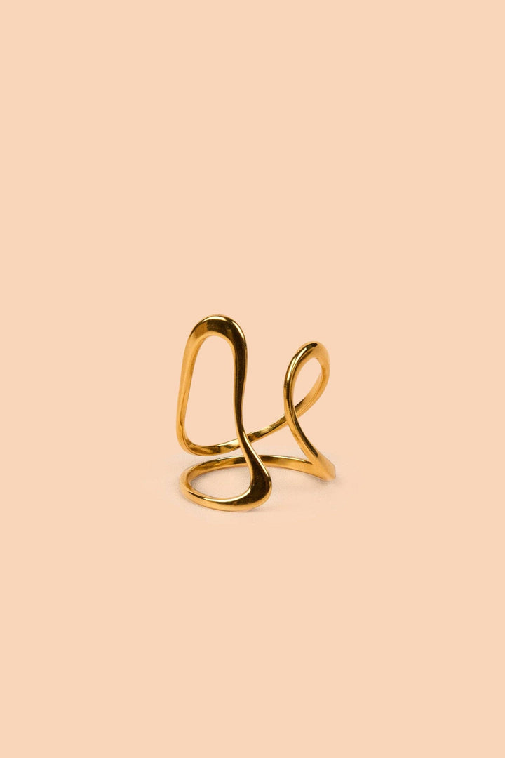 Gold adjustable ring on a beige background