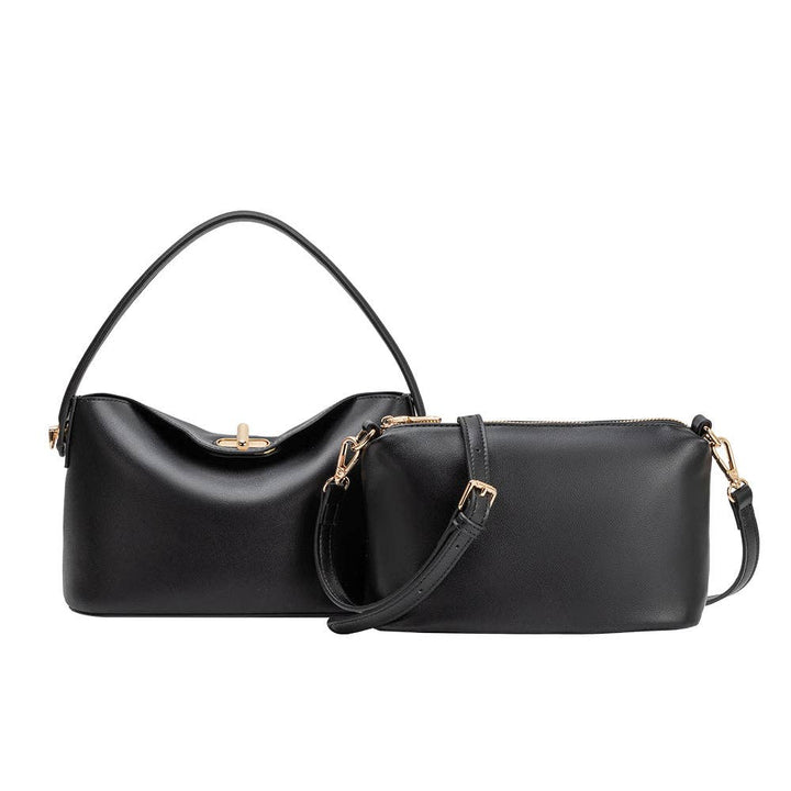Black vegan leather handbag with gold accents on a white background