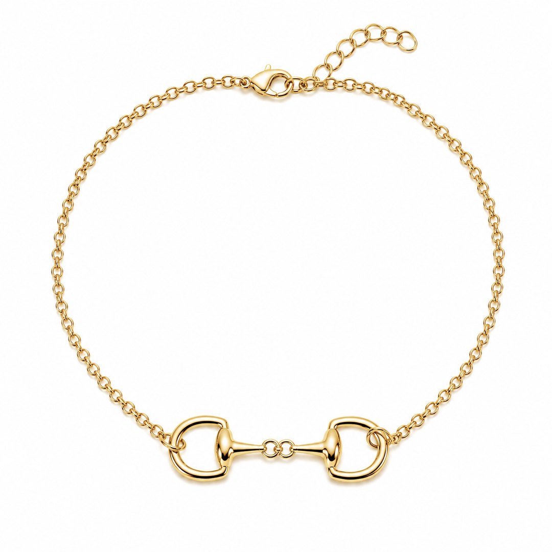 A gold horsebit chain bracelet with a central horsebit motif and an adjustable lobster clasp, shown on a plain white background.