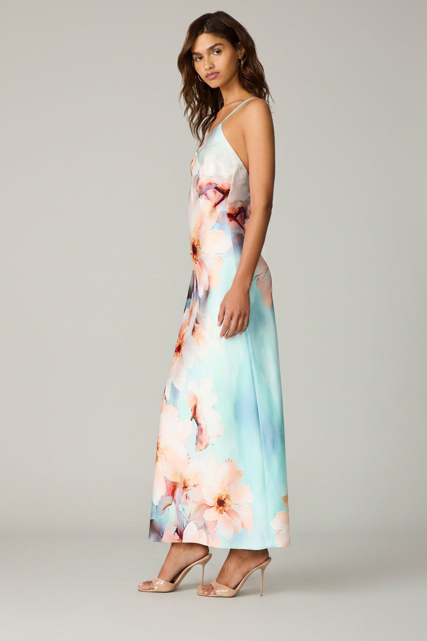 Woman wearing a floral maxi dress on a white background